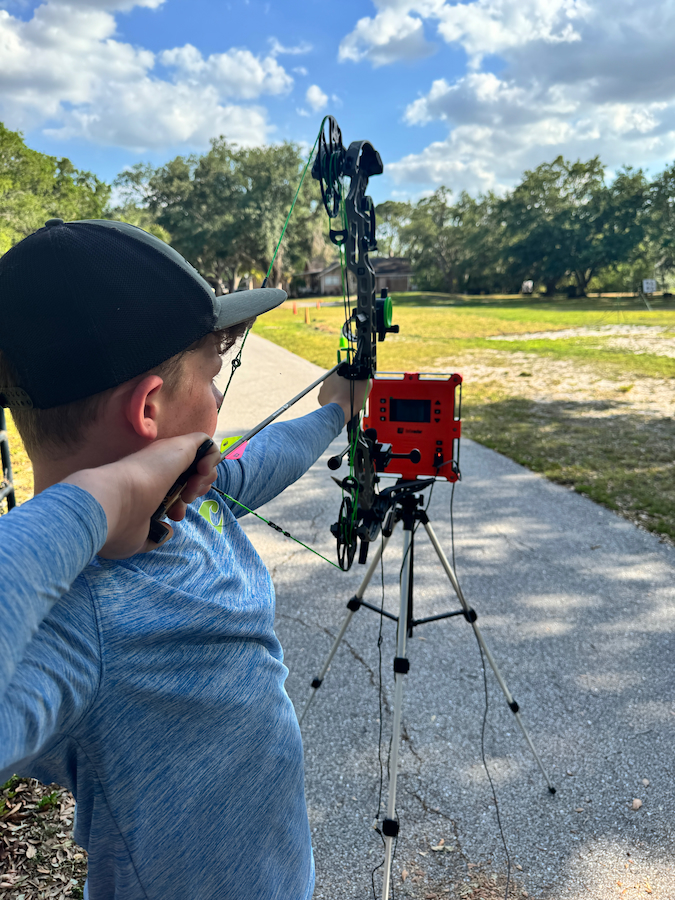 Archer using labradar for custom sight tape at Sarasota Archery Academy