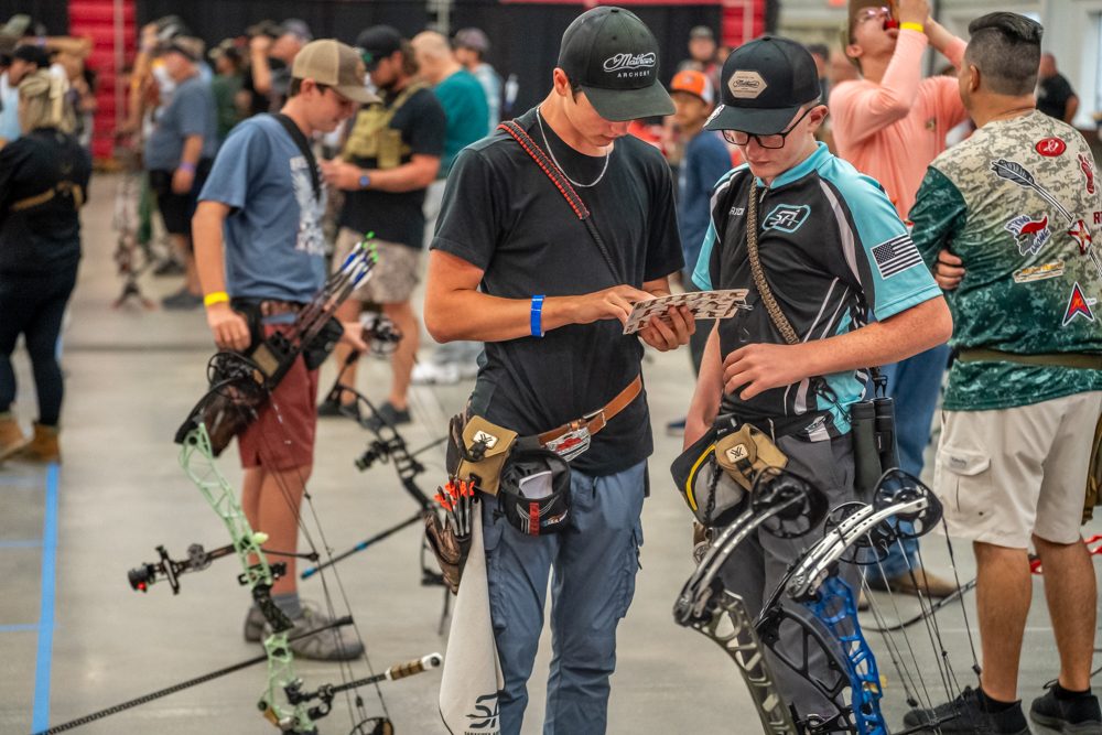 Sarasota Archery Academy archers checking scorecards at a USA Archery tournament